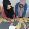 Two women handmaking wool felt slippers