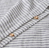 Close up of grey stripe duvet cover with olive wood buttons