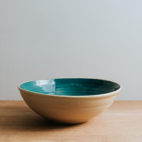 Natural stoneware serving bowl with teal interior
