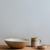 Set of stoneware with serving bowl, mug and dish all with natural finish and white glaze