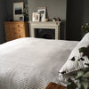 Striped bed linen in a dark grey bedroom