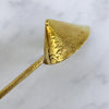 Closeup of brass candle snuffer