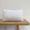 Grey and white Stripe Linen Lumbar Cushion On A Wooden Bench