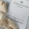 Closeup of Letterpress Gift Voucher With Peach Ribbon