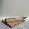Two wooden chopping boards on a marble counter